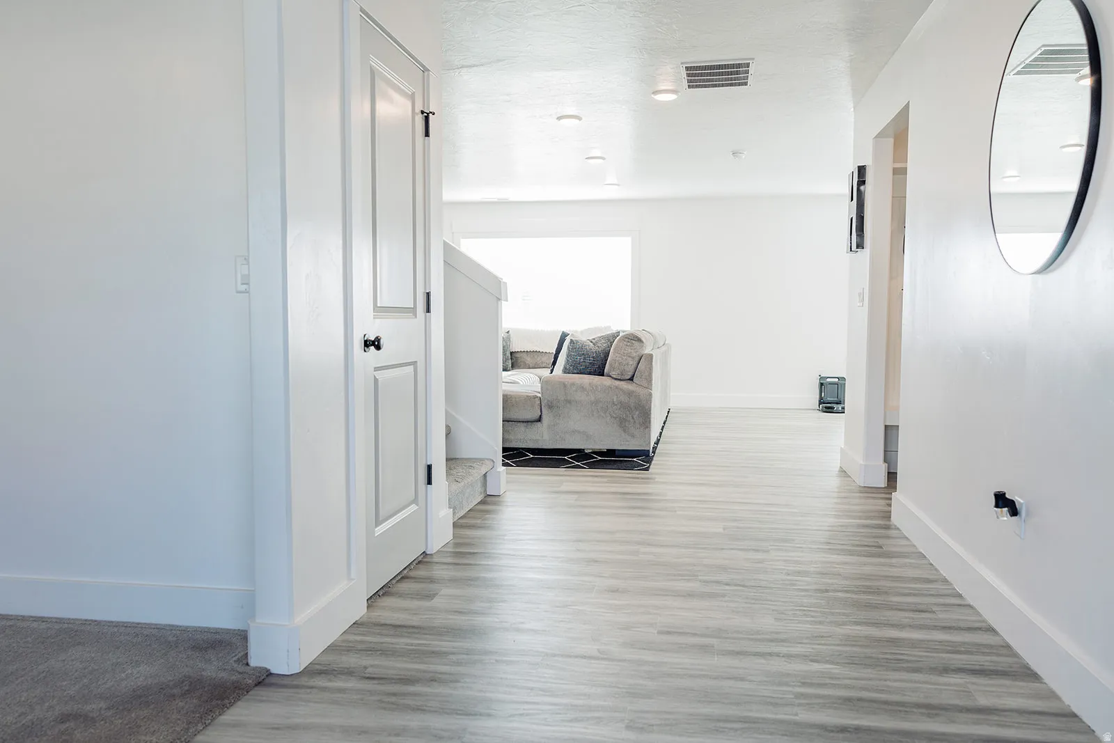 Open interior space featuring wood-finish flooring, white walls, and recessed lighting