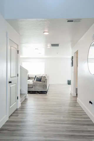 Entryway featuring wood-finish flooring and white baseboards