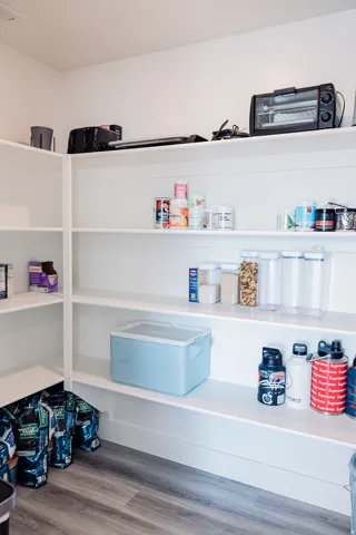 Custom built-in pantry shelving provides ample storage
