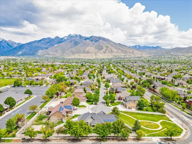 Expansive residential area featuring established homes, mature trees, and mountainous scenery