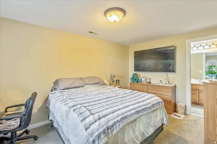 Bedroom featuring light-toned walls and neutral carpet