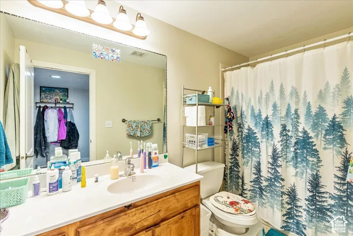 Bathroom featuring a light wood vanity with a white countertop and integrated sink