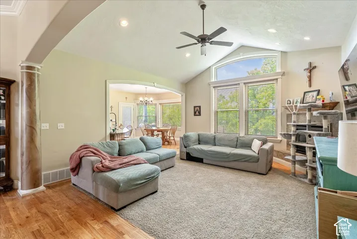 Spacious living area featuring a vaulted ceiling with recessed lighting and a ceiling fan