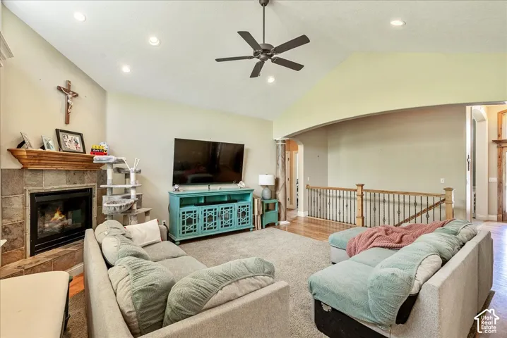 Living space featuring vaulted ceilings, recessed lighting, and a ceiling fan