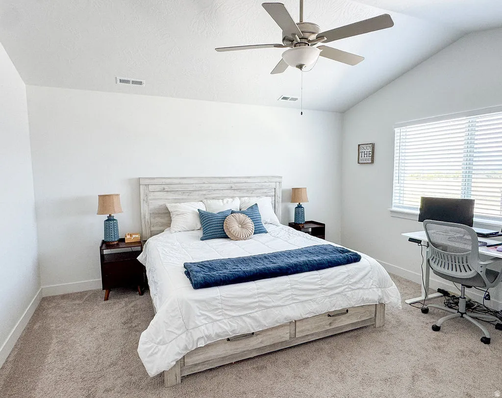 Bedroom featuring vaulted ceilings, a ceiling fan, carpeted flooring, a window with blinds, and white baseboards