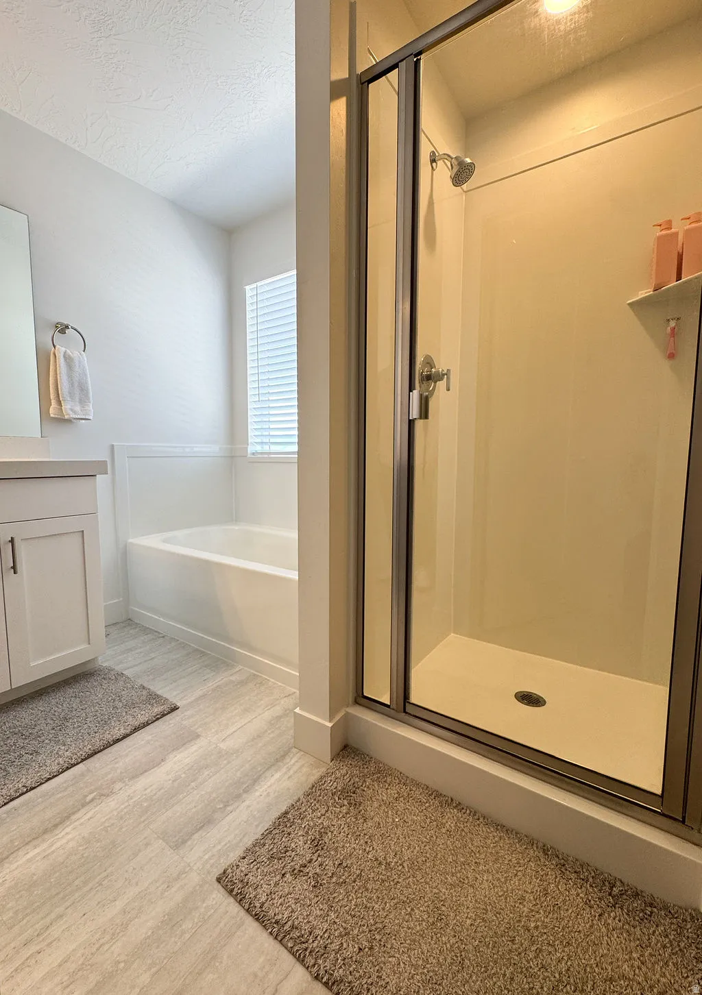 Walk-in shower with clear glass enclosure and chrome fixtures