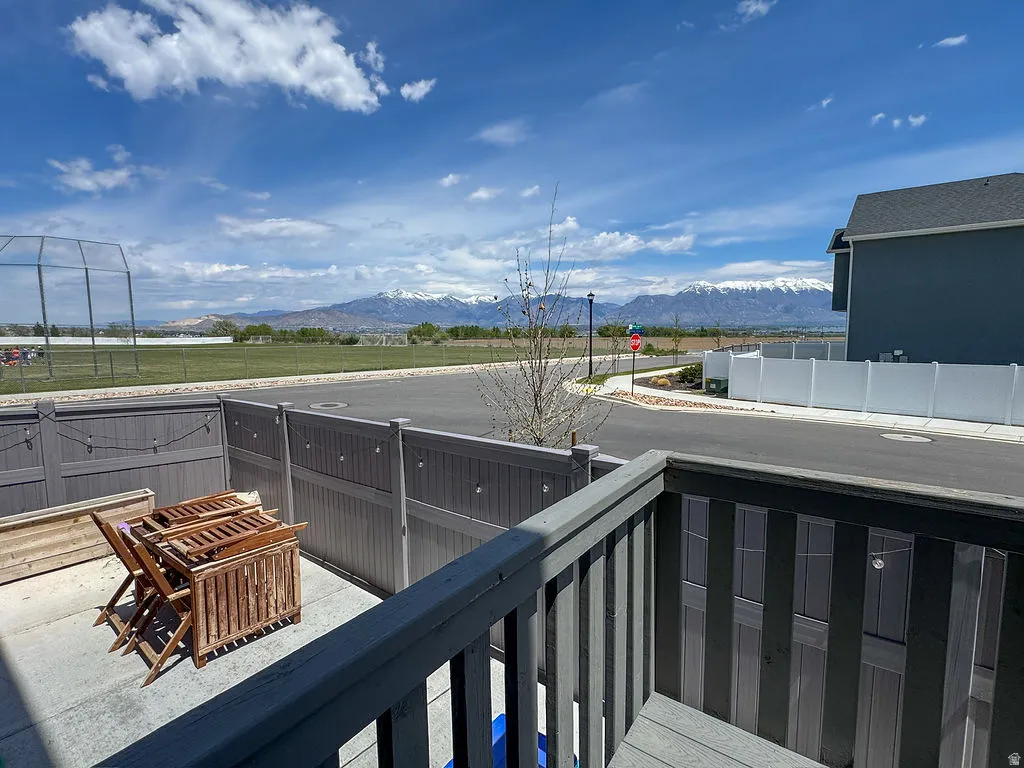 Private concrete patio area featuring a slatted privacy fence