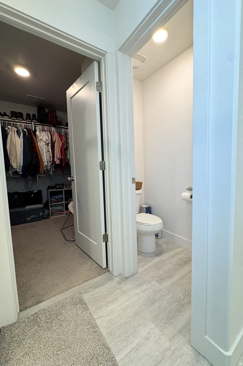 Powder room featuring a ceramic tile floor, white toilet, and recessed lighting