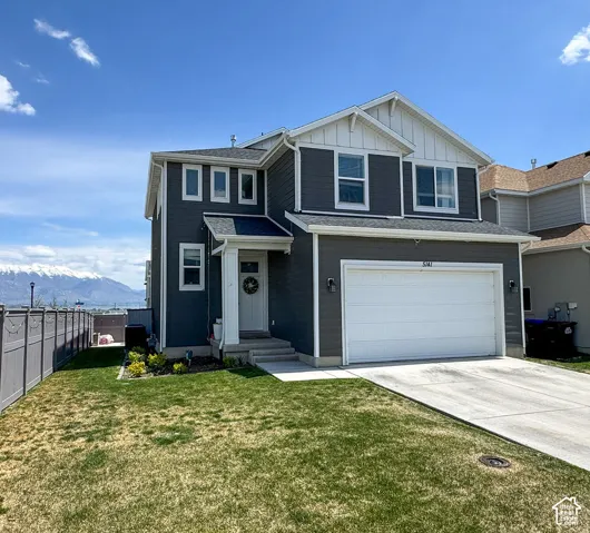 Two-story home with dark gray siding and white trim