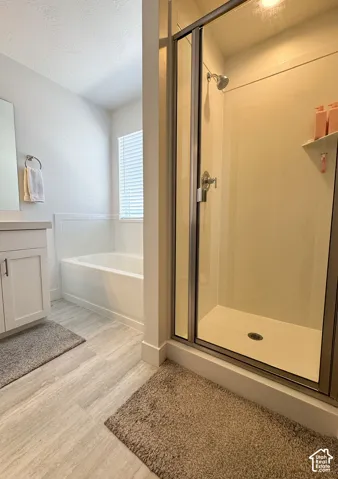 Walk-in shower with clear glass enclosure and chrome fixtures