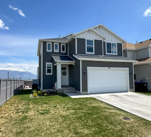 Two-story home with dark gray siding and white trim