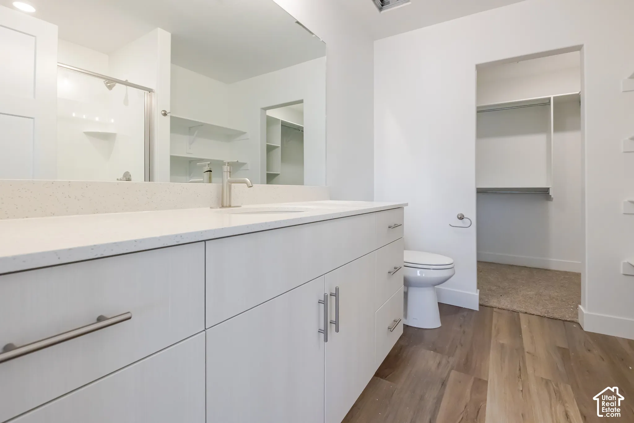 Dual sink vanity with white cabinetry and brushed nickel hardware