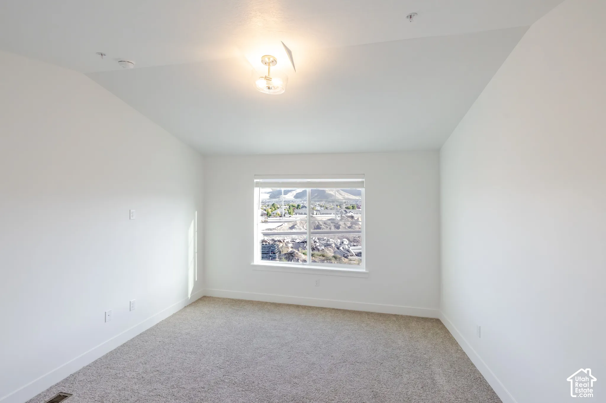 Carpeted flooring, vaulted ceiling, recessed lighting, double-pane window