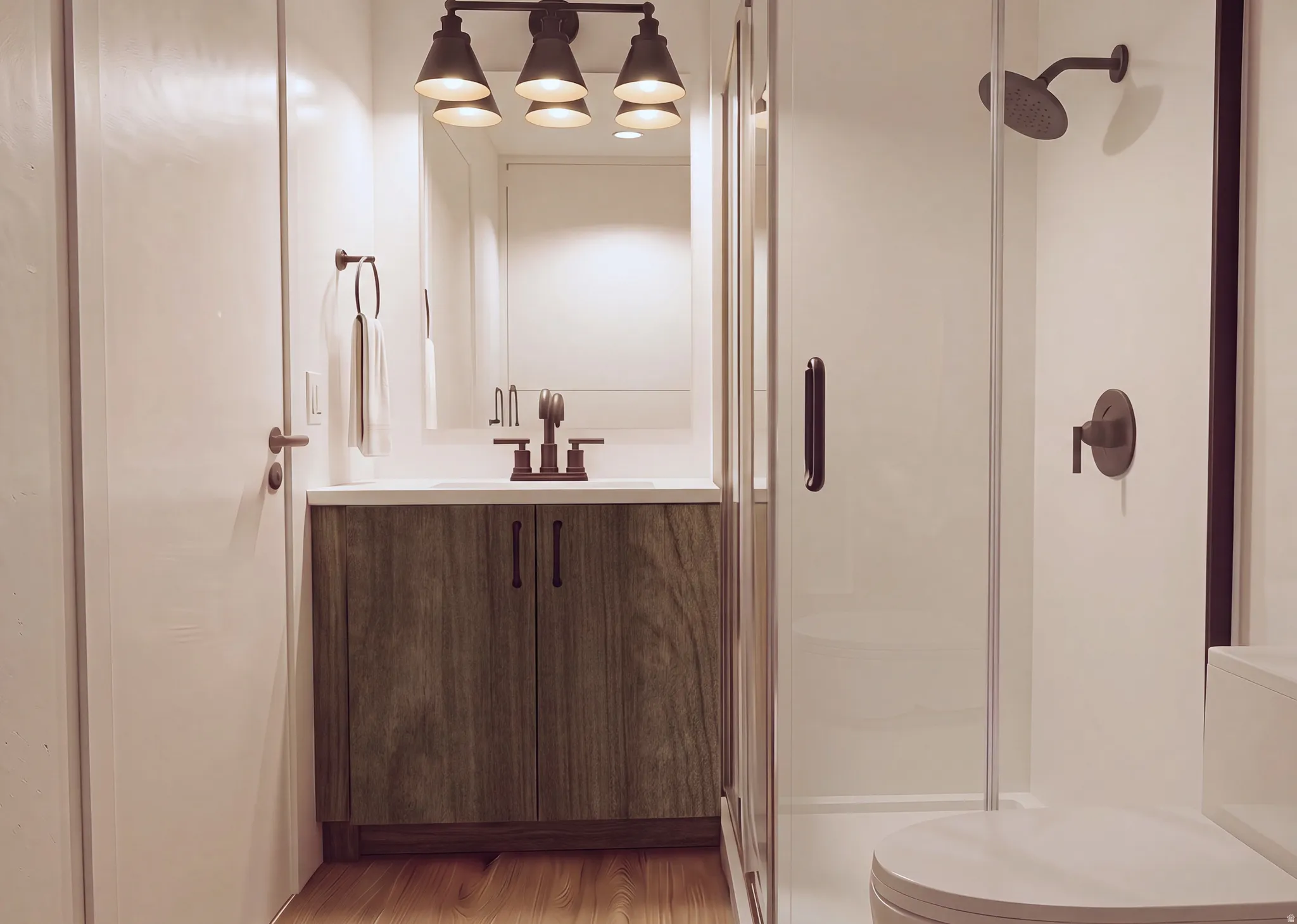 Bathroom featuring a wood-finish vanity with a white countertop, a bronze-finish faucet, and a frameless glass shower enclosure with bronze-finish fixtures