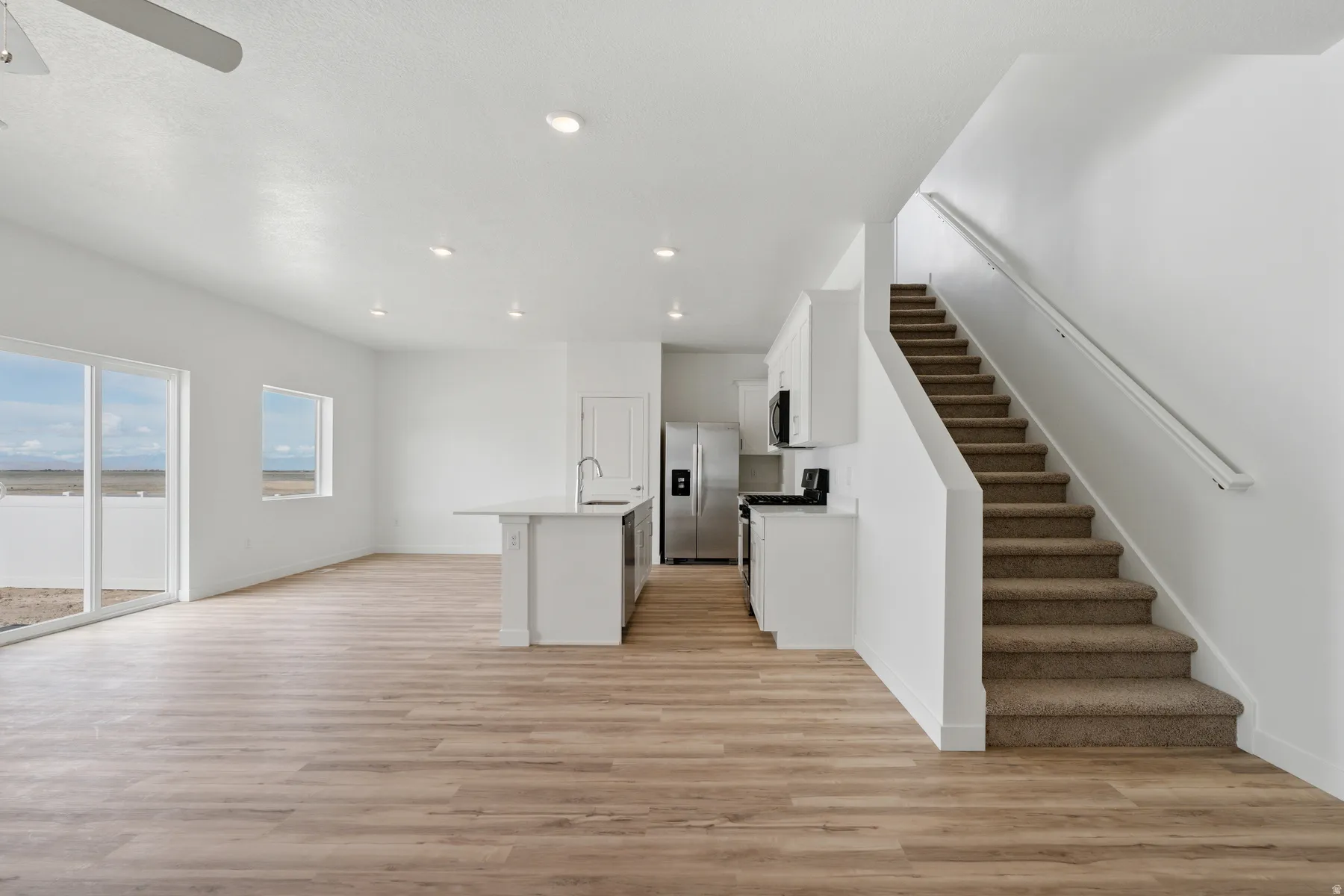 Open-concept living space with wood-finish flooring