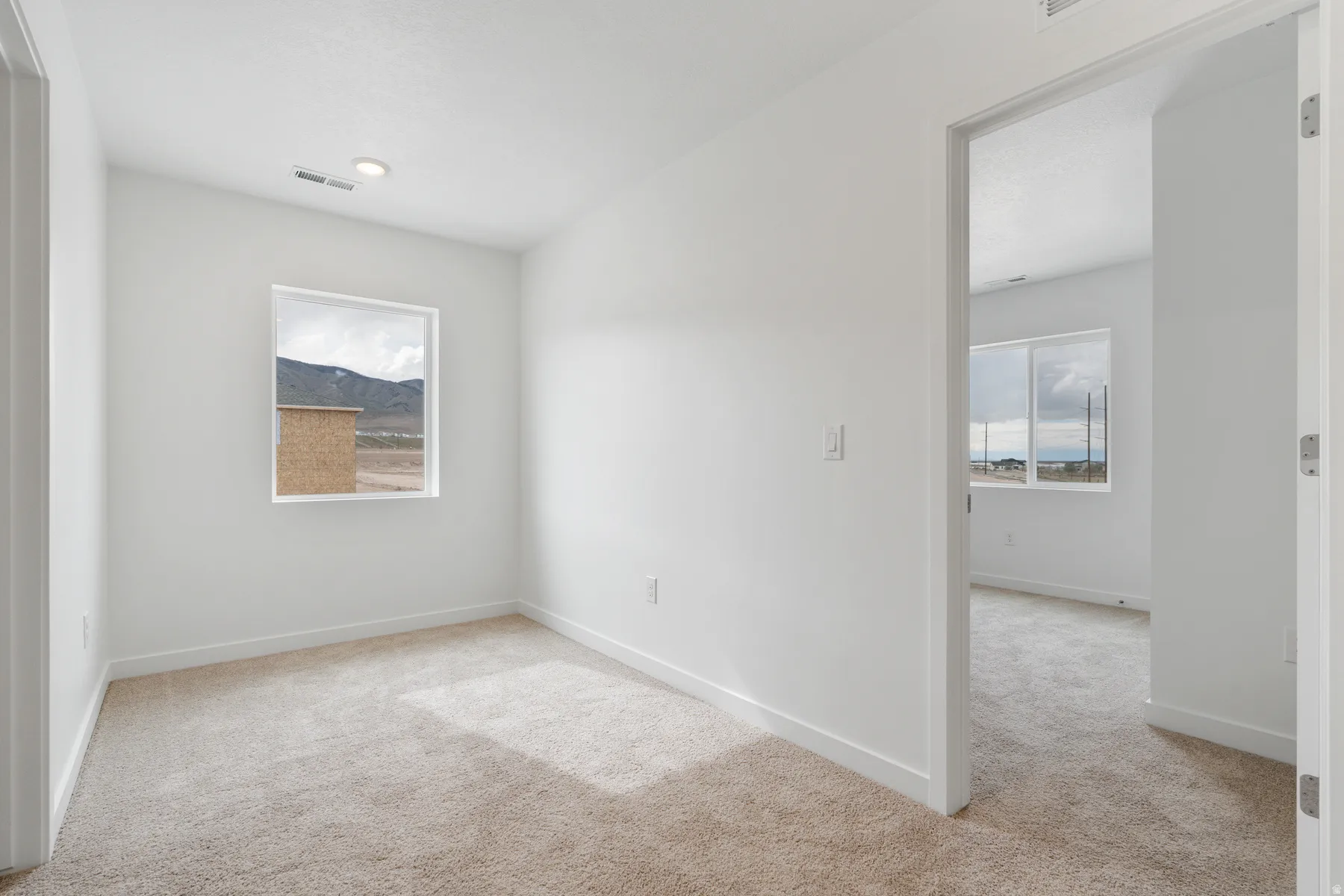 Bright interior space featuring neutral wall finishes and plush carpeting