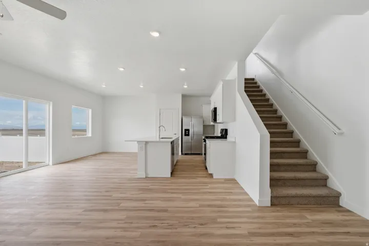 Open-concept living space with wood-finish flooring