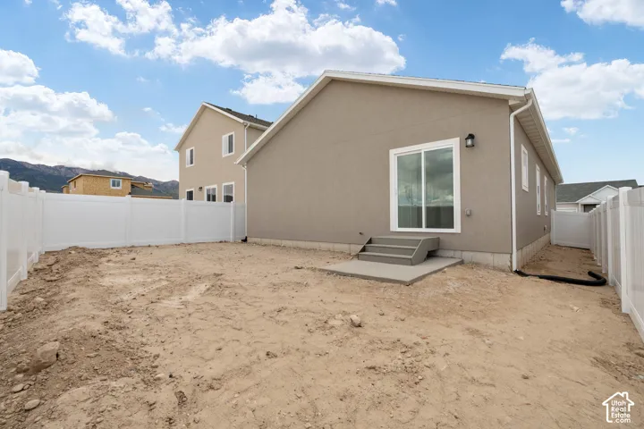 Sliding glass door access to the exterior, concrete steps, and a fully fenced property