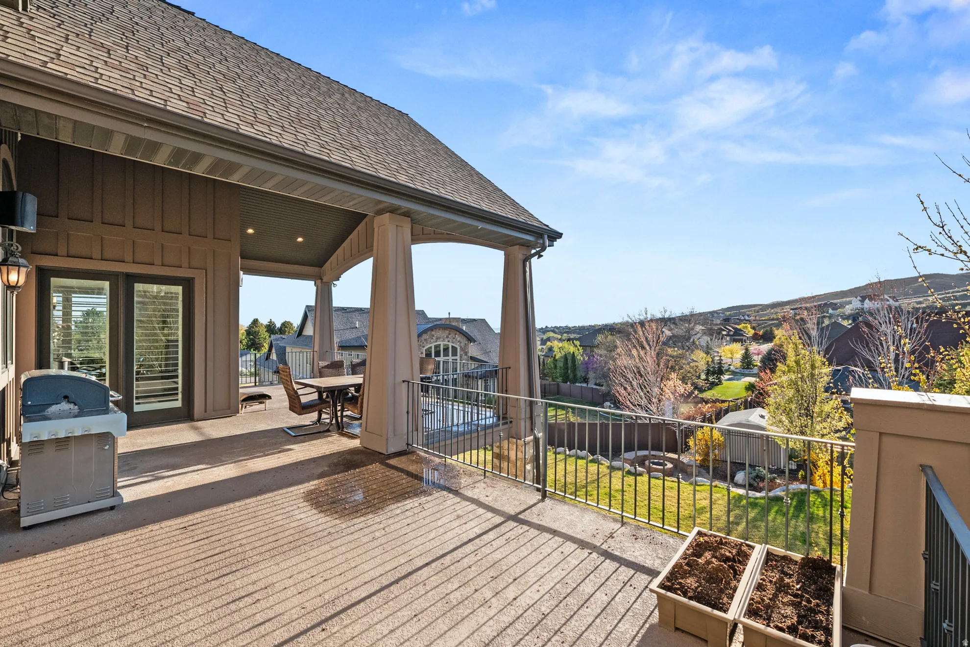 Expansive covered deck featuring recessed lighting, a ceiling fan, and access through double glass doors with interior shutters
