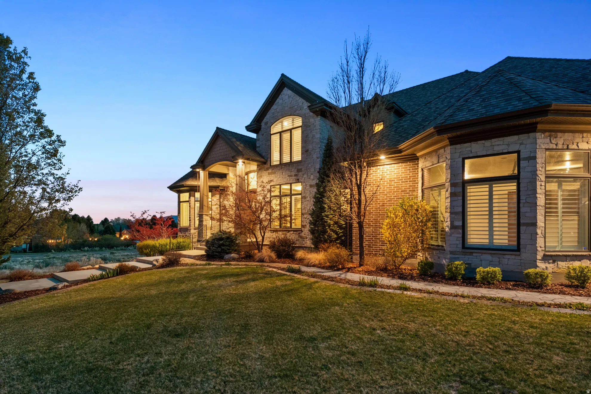 Stone and brick exterior with multiple windows and dark trim