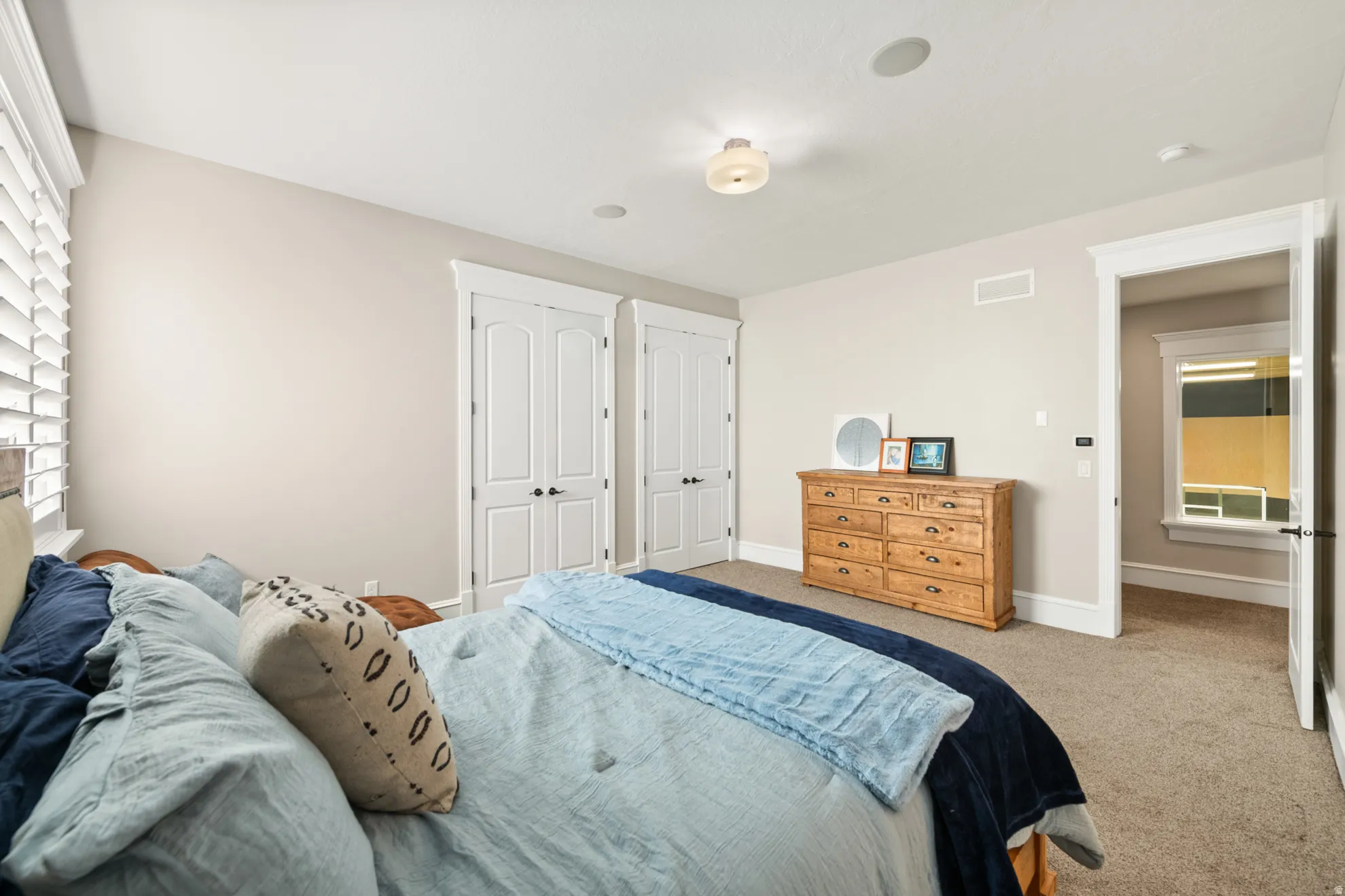 Neutral-toned walls complement plush carpeting