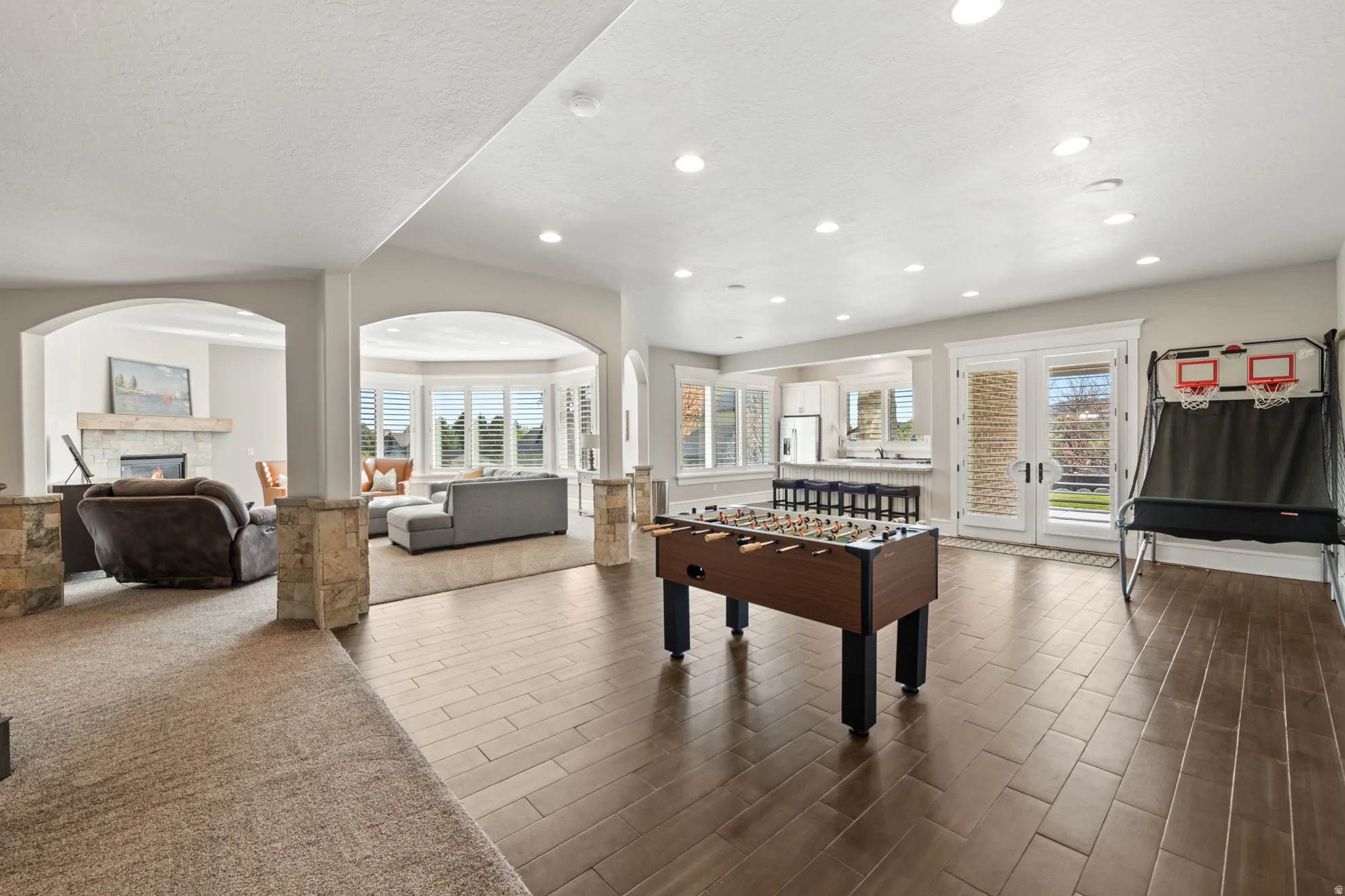Spacious lower level featuring wood-finish flooring, recessed lighting, and white trim