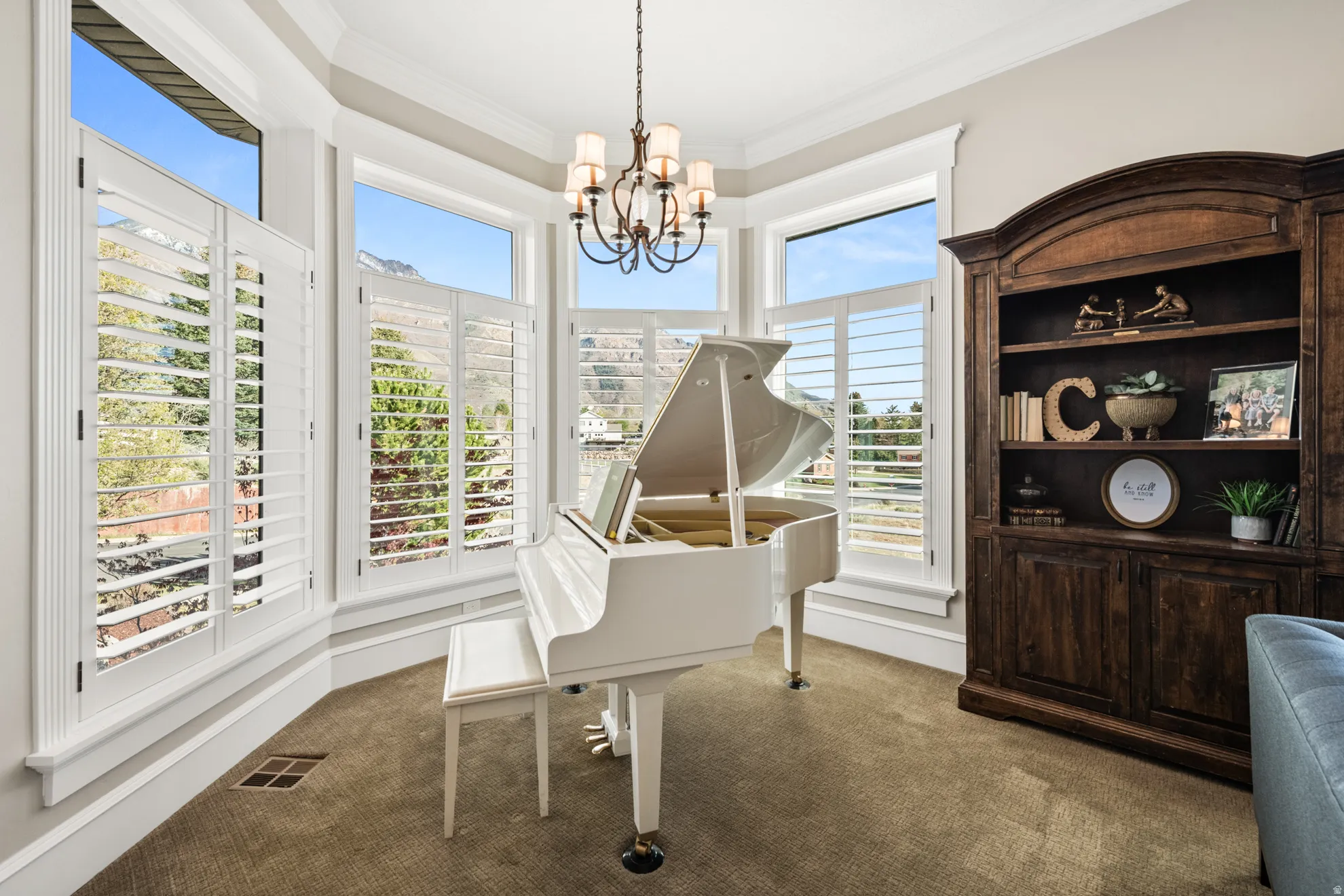 Bay window with plantation shutters and mountain scenery