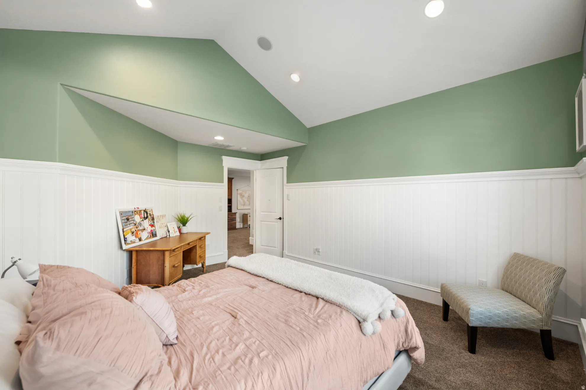 Vaulted ceiling bedroom featuring recessed lighting, two-tone wall treatment with beadboard wainscoting, and carpet flooring