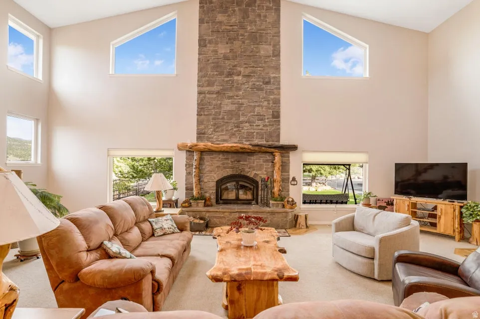 Vaulted ceilings with high-set trapezoidal windows characterize this living area