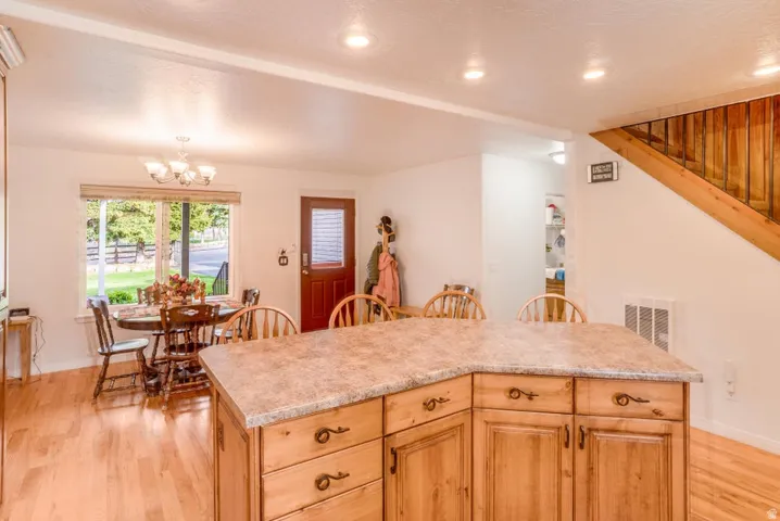 Kitchen island with wood-finish cabinetry and a textured countertop