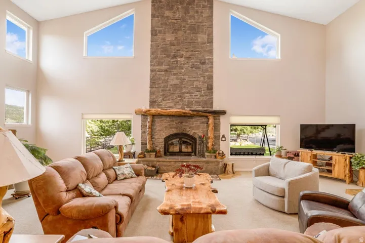 Vaulted ceilings with high-set trapezoidal windows characterize this living area