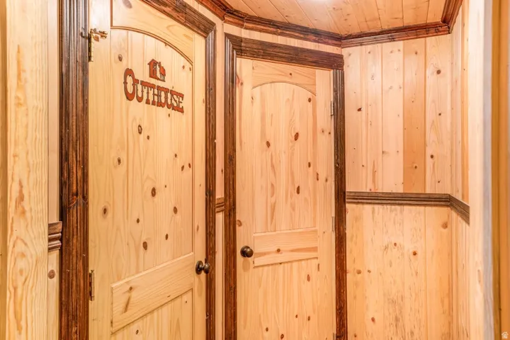 Paneled wood walls featuring knotty pine planks and dark stained wood trim