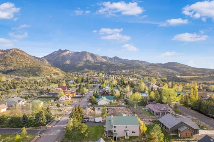 Expansive mountain panorama framing a neighborhood of diverse residences