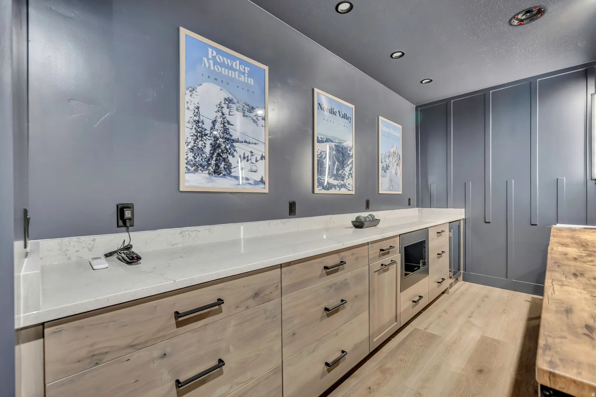 Full bath with vanity, light wood finished floors, recessed lighting, and a textured ceiling