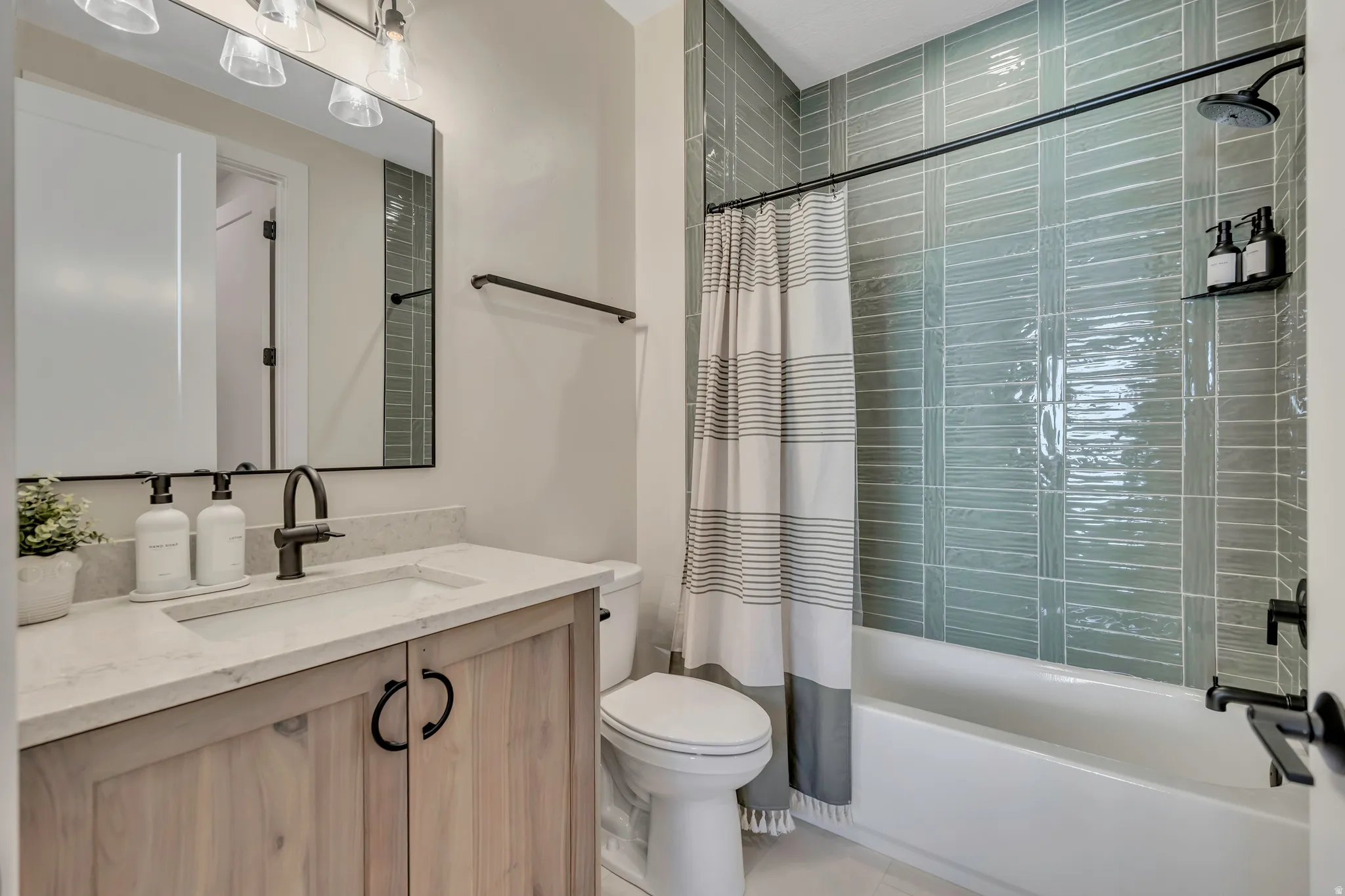 Full bath with vanity and shower / bath combo with shower curtain