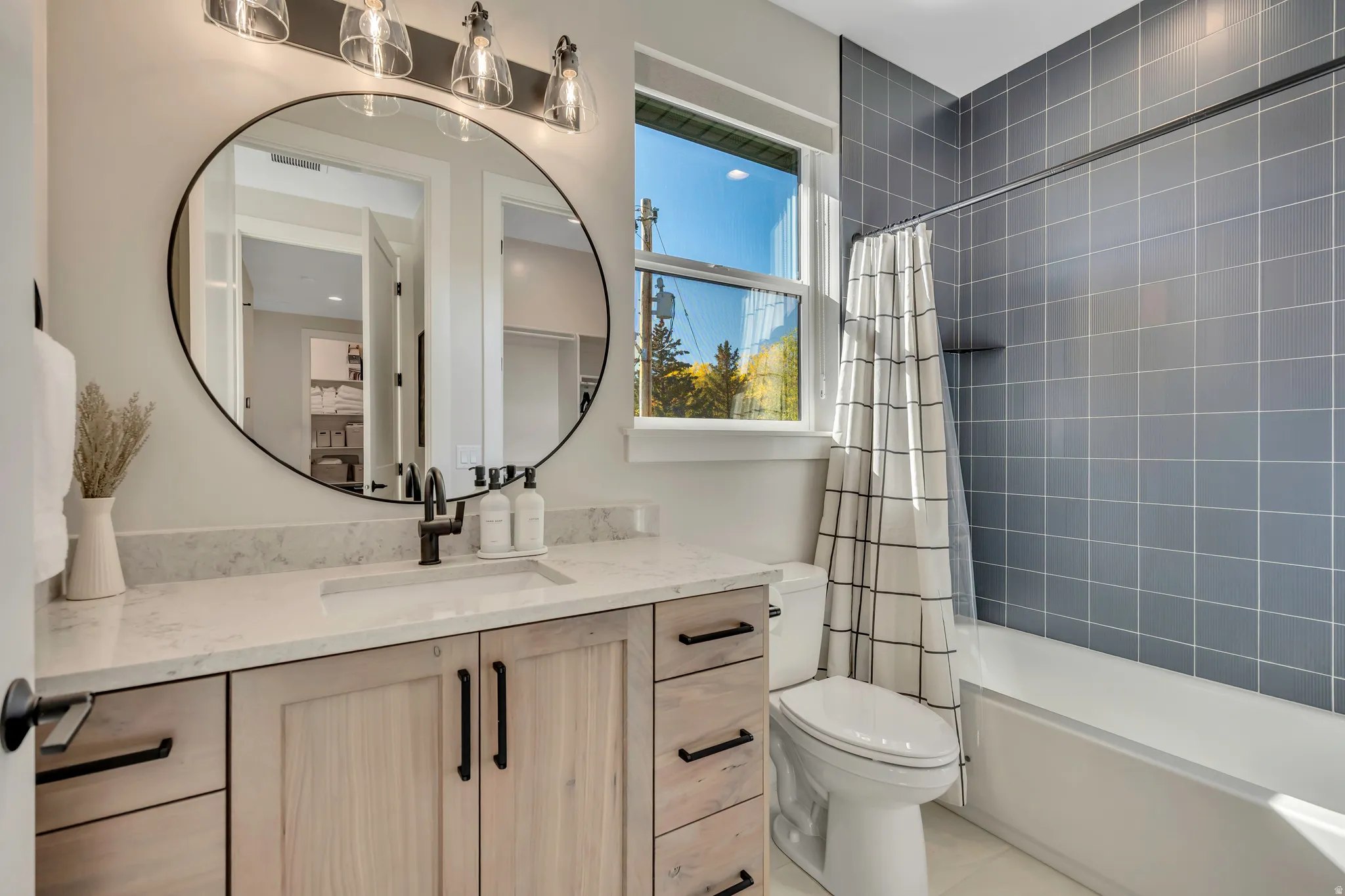 Full bath with vanity, shower / bath combination with curtain, and light tile patterned flooring