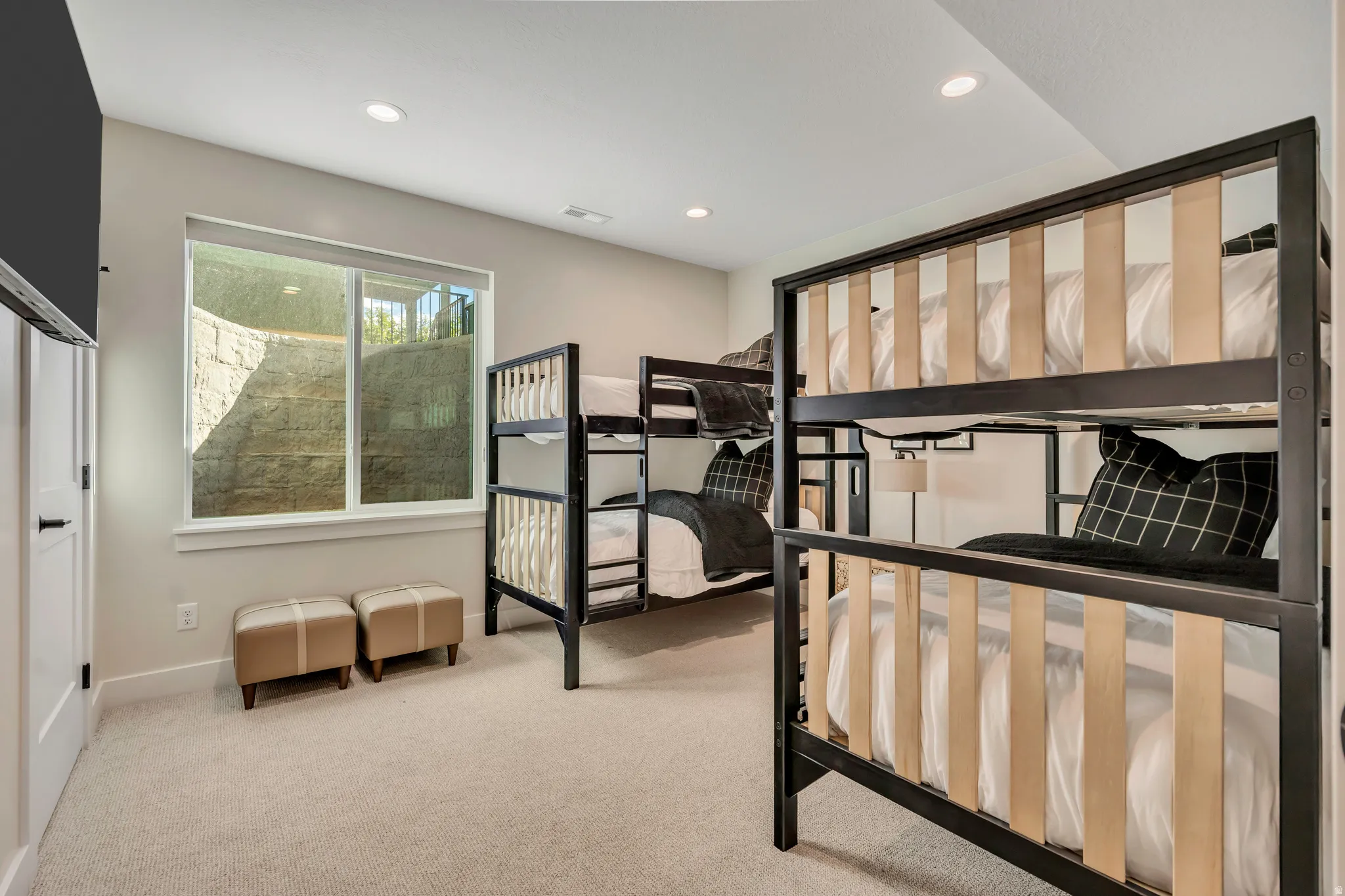 Bedroom with light colored carpet and recessed lighting