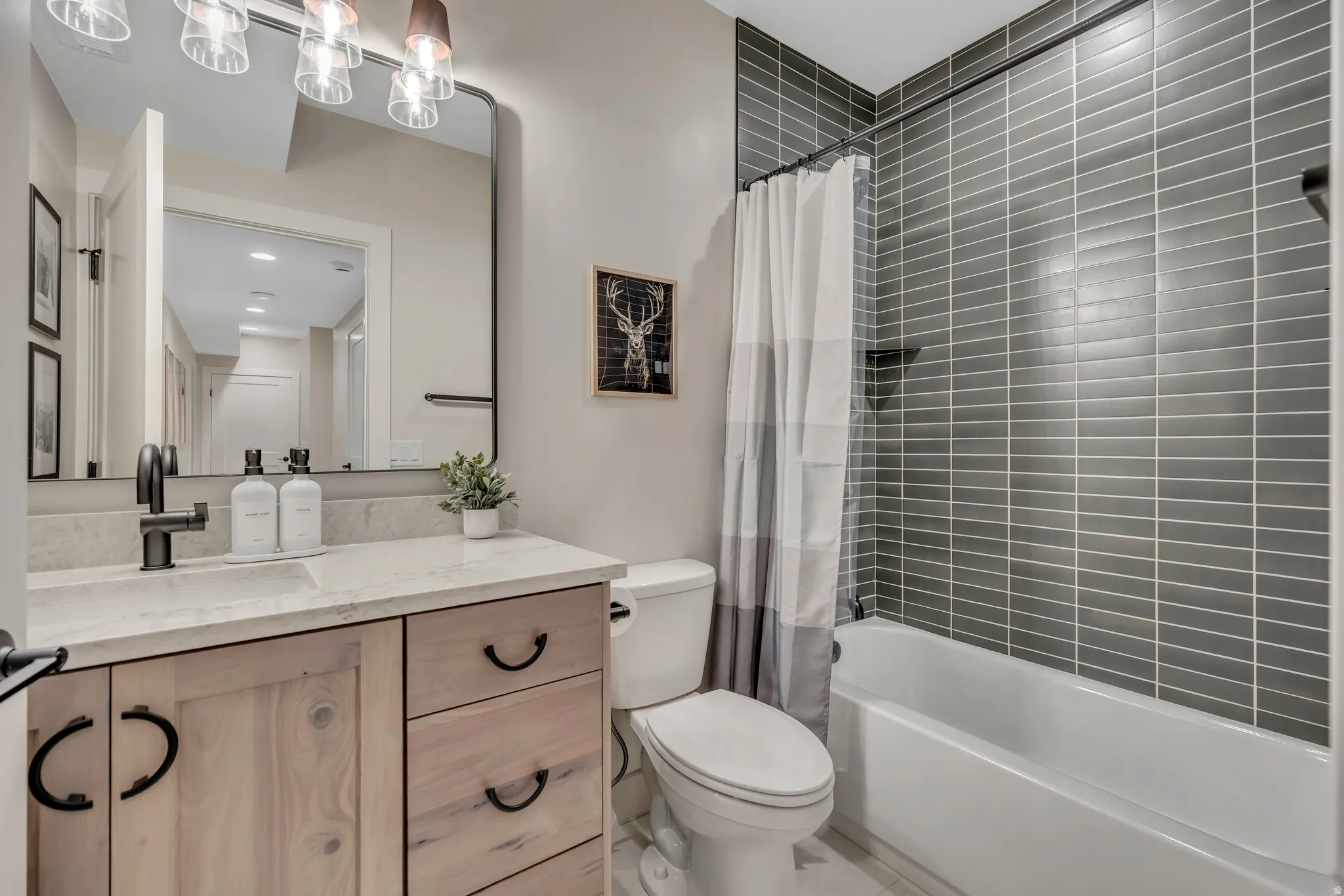 Bathroom with vanity, shower / bathtub combination with curtain, and recessed lighting