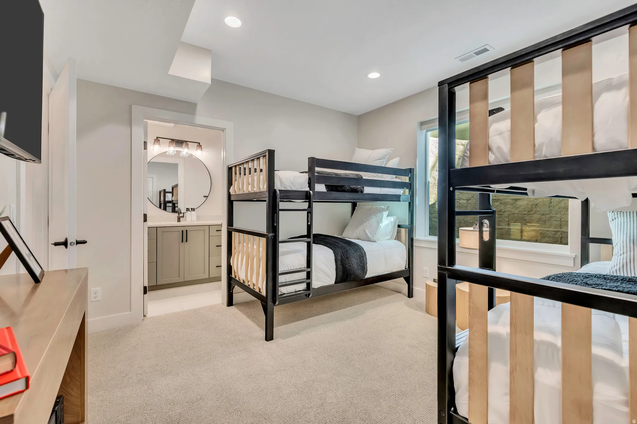 Unfurnished bedroom featuring light carpet, recessed lighting, and ensuite bath