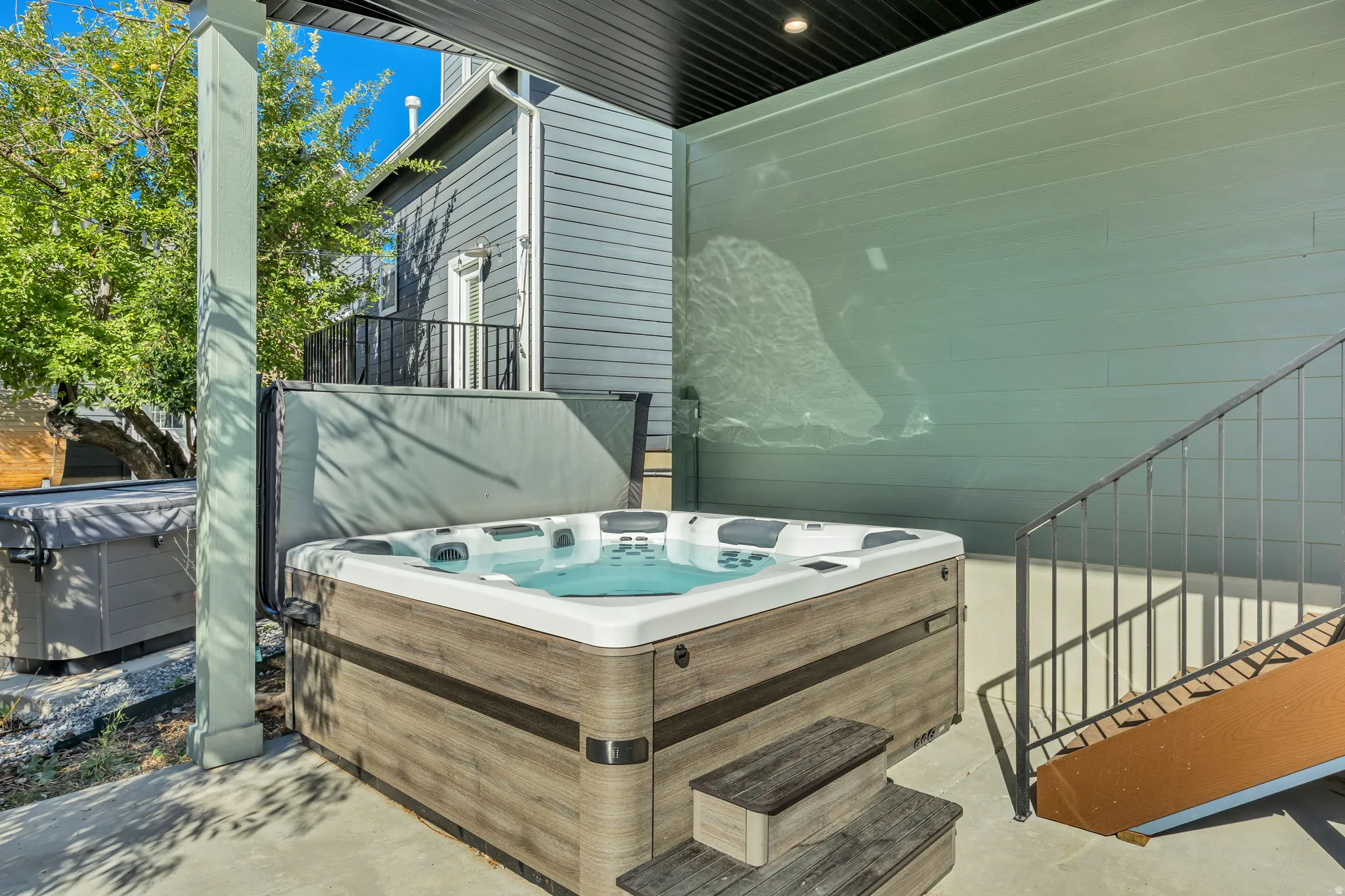 View of patio with a hot tub