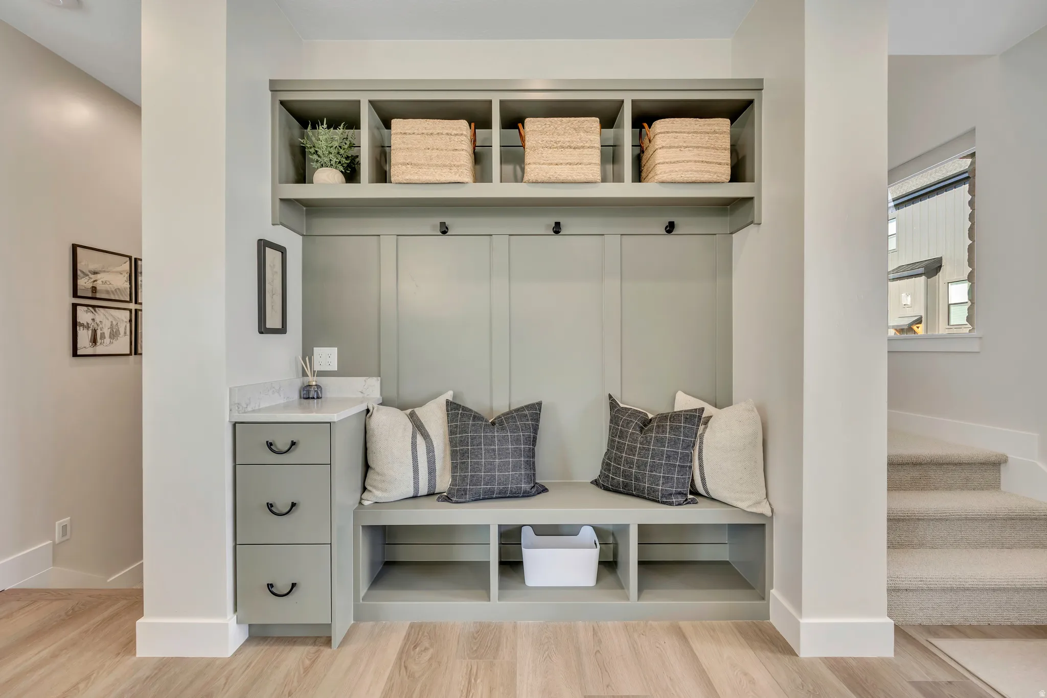 Mudroom with light wood-style flooring and baseboards