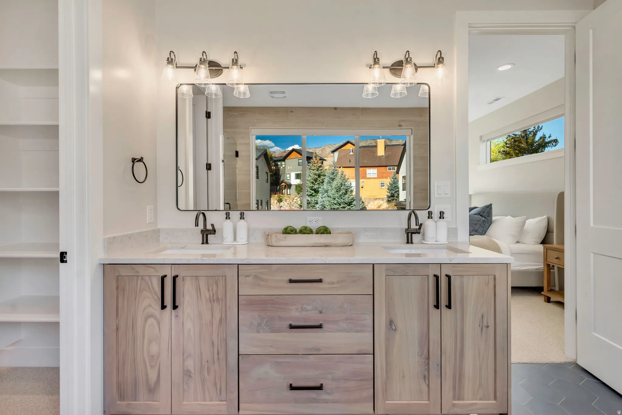 Full bath with double vanity, connected bathroom, and carpet flooring