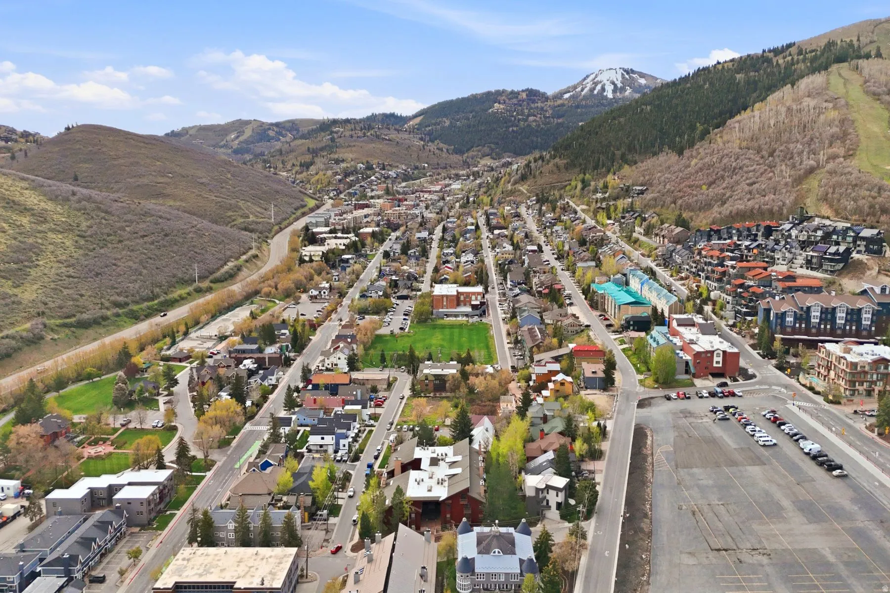 Expansive aerial perspective showcasing a mountainous terrain with a central town layout