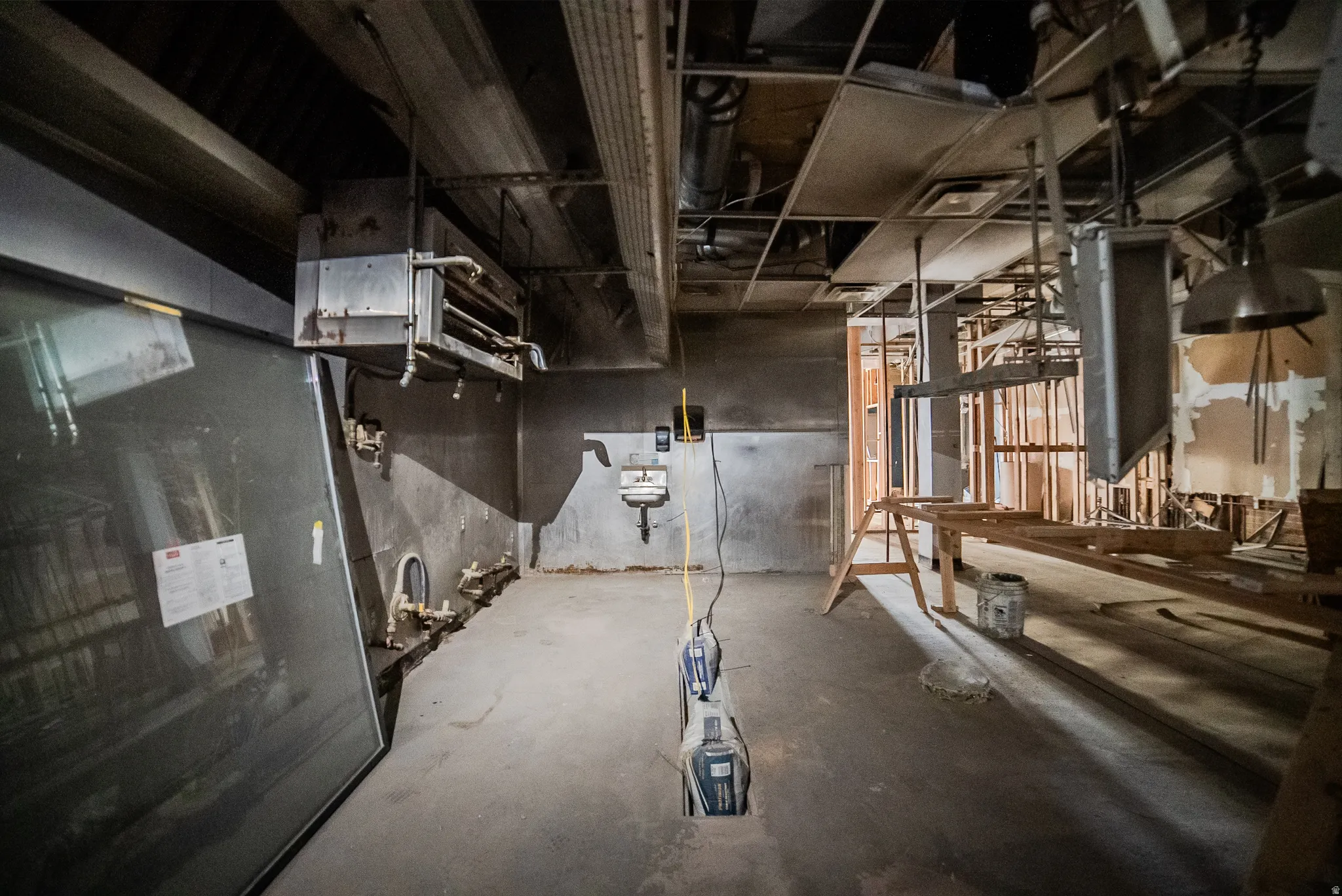 Unfinished below grade area with a heating unit