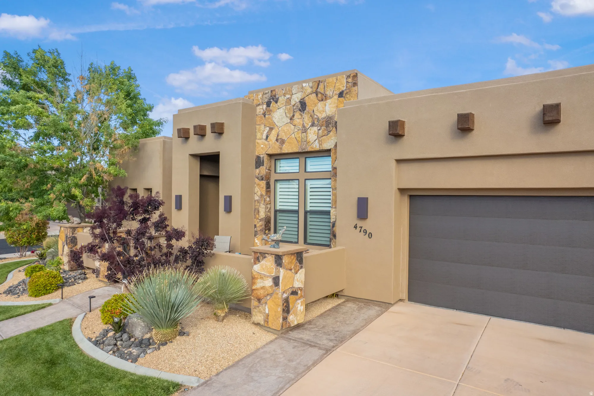 Contemporary stucco exterior with stone accents