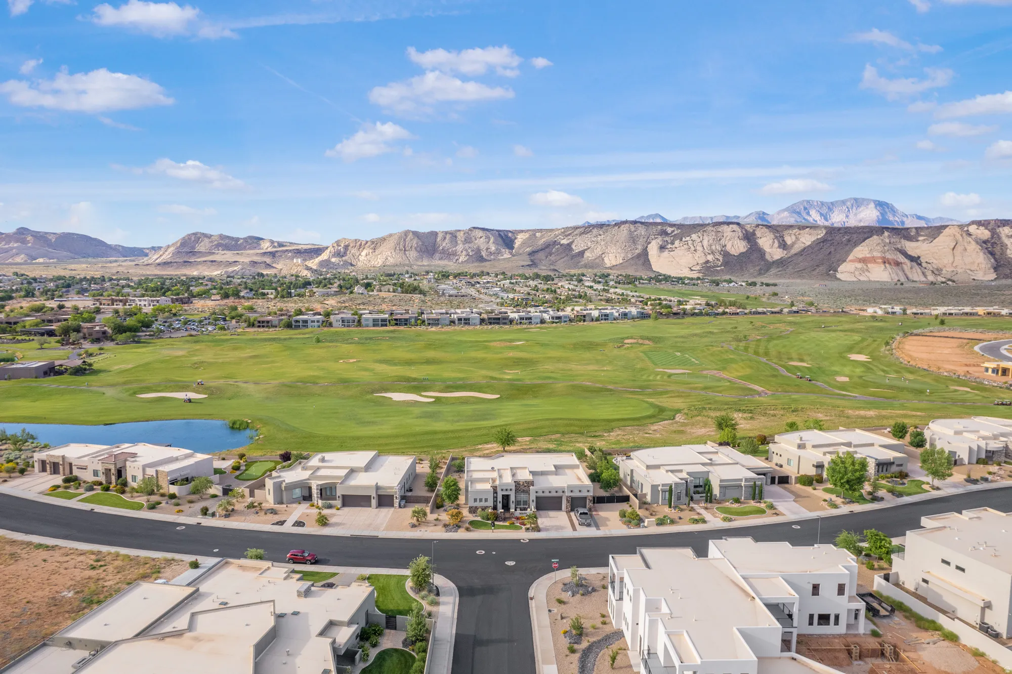 Expansive golf course and mountain scenery with modern residences