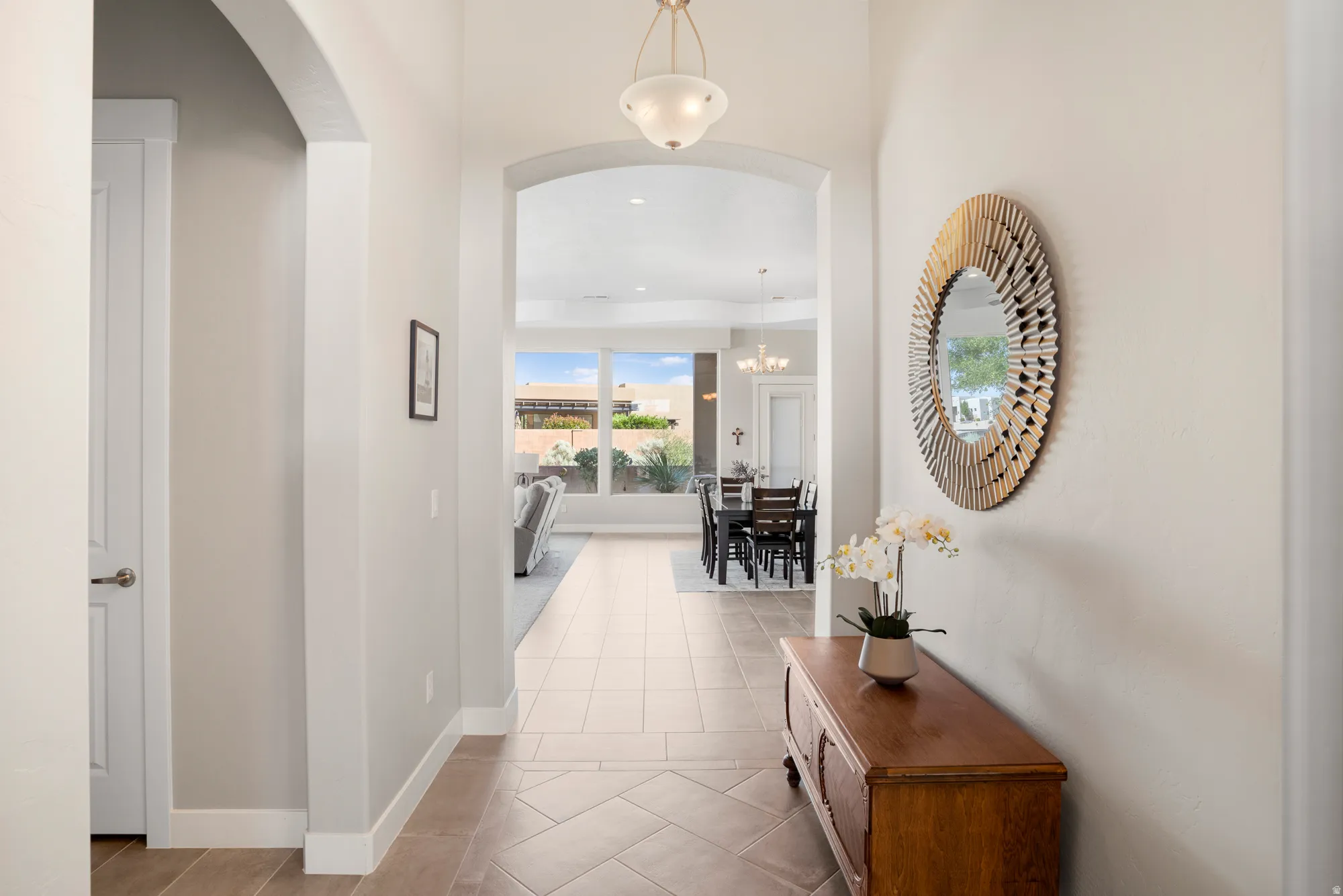 Entryway featuring tile flooring, an arched doorway, and recessed ceiling lighting