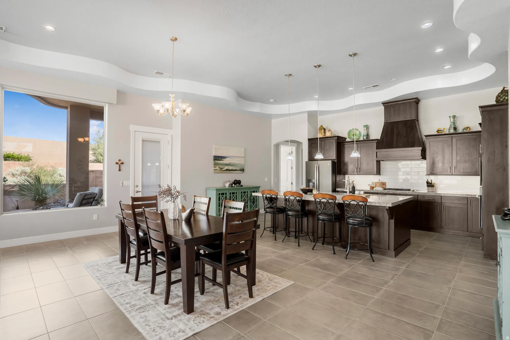 Open-concept kitchen and dining area featuring tile flooring