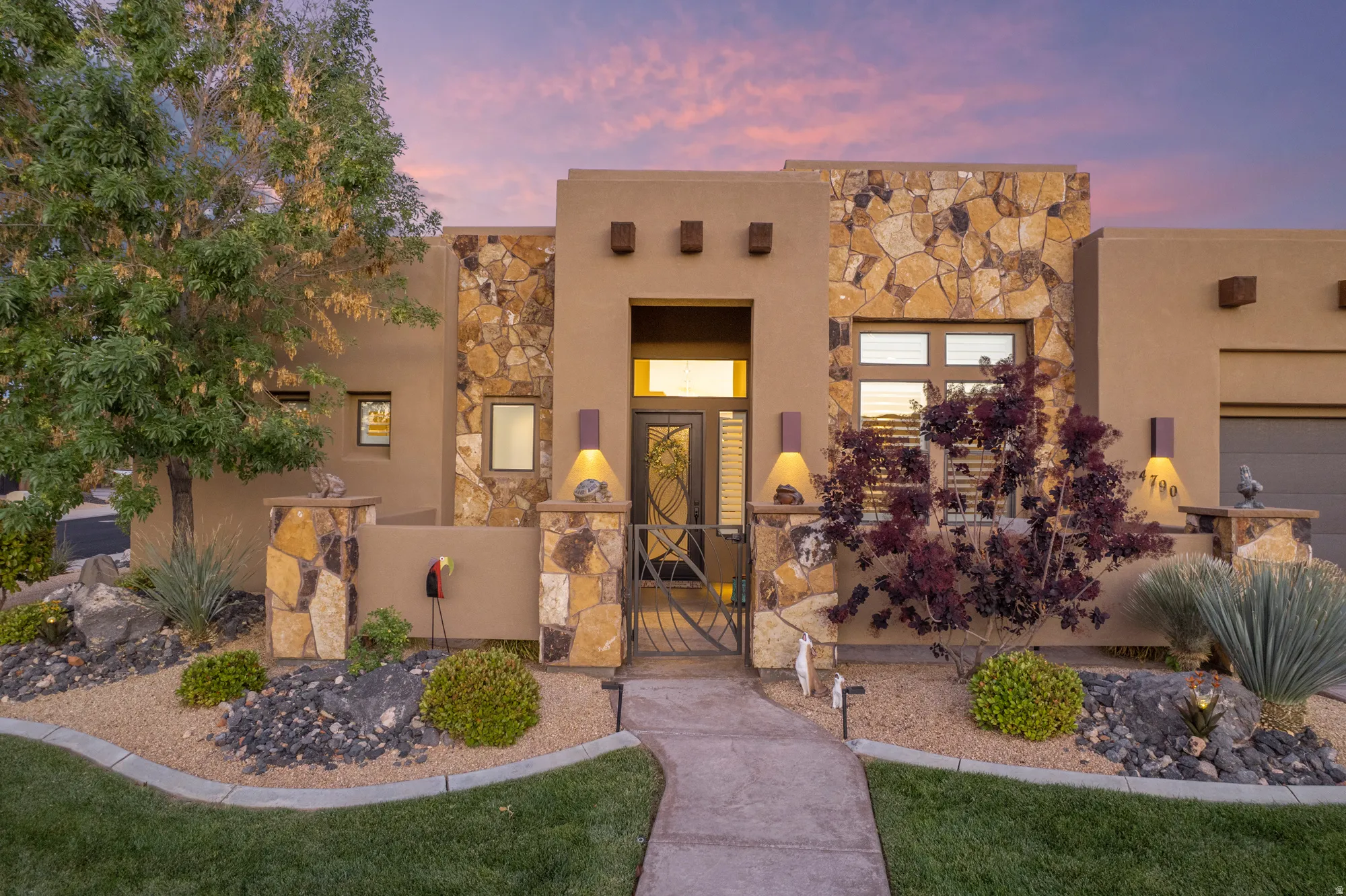 Southwestern-style exterior featuring stucco and natural stone accents