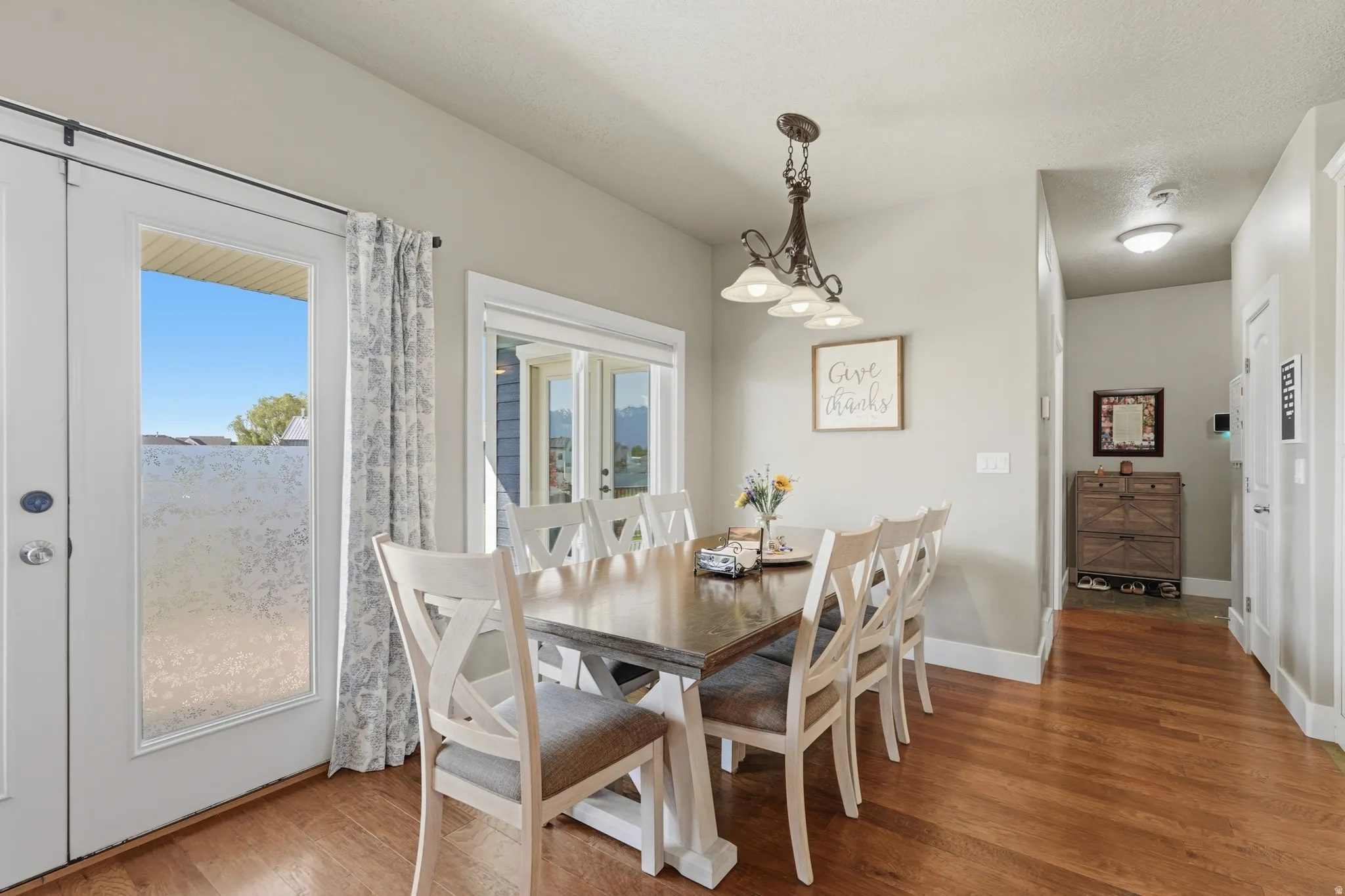 Dining area featuring wood-finish flooring and a multi-light chandelier